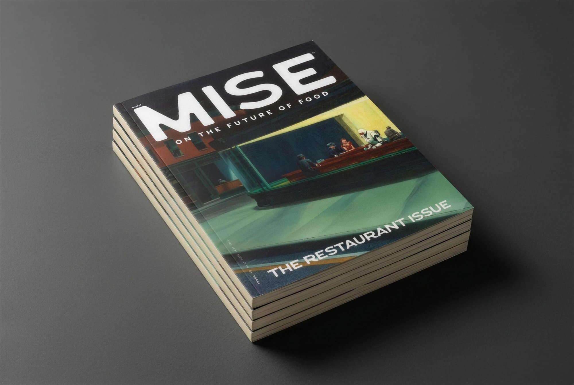 A stack of MISE 02: The Restaurant Issue, its cover a robot seated at the counter of Edward Hopper's Nighthawks diner